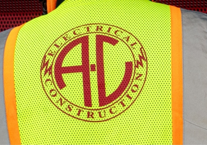 contact hero A-C Electric Company worker's vest with logo